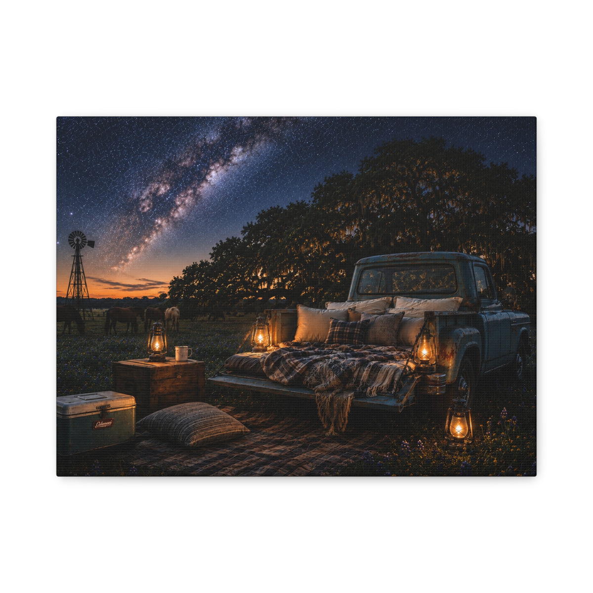 A rectangular Starry Night canvas print showing a cozy outdoor bed beside a vintage pickup in a country field, with lanterns, pillows, blankets, windmills, and the Milky Way overhead, photographed on a white background.