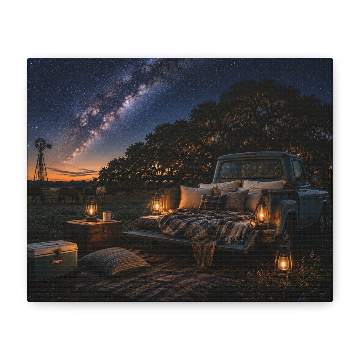 A rectangular Starry Night canvas print showing a cozy outdoor bed beside a vintage pickup in a country field, with lanterns, pillows, blankets, windmills, and the Milky Way overhead, photographed at an angle on a white background.
