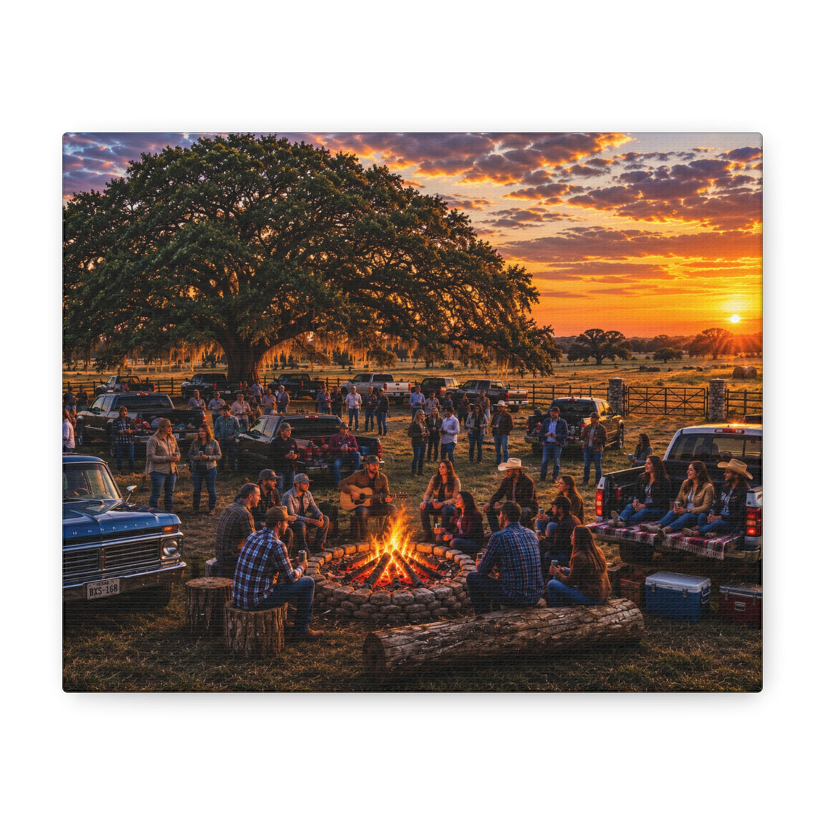 A rectangular wall art print or canvas showing a sunset campfire scene with people gathered outdoors under a large tree, displayed against a plain white background.