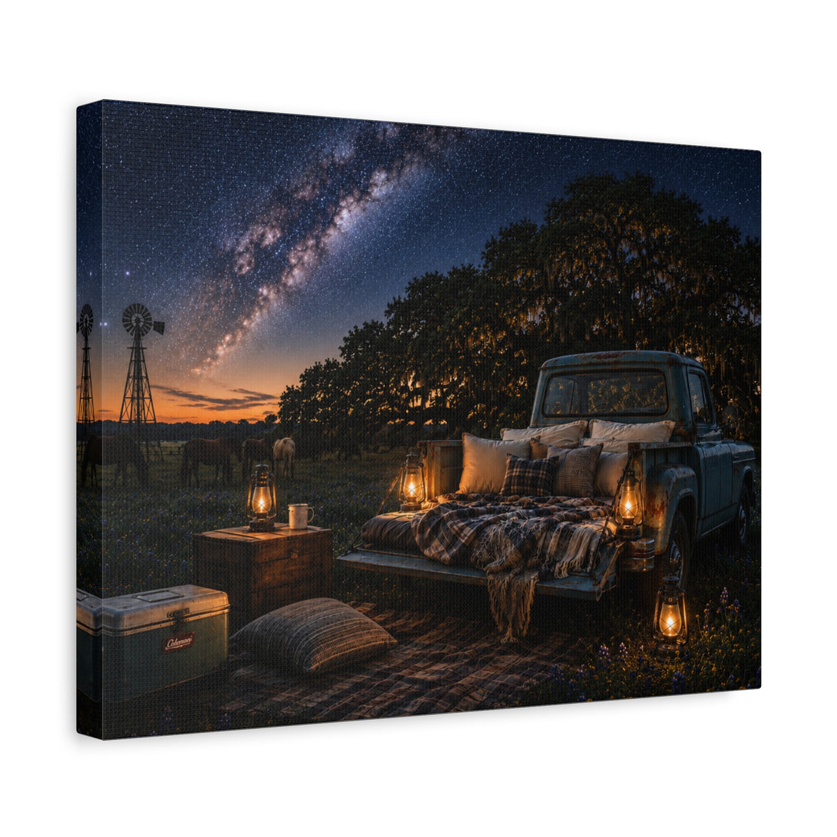 A rectangular Starry Night canvas print showing a cozy outdoor bed beside a vintage pickup in a country field, with lanterns, pillows, blankets, windmills, and the Milky Way overhead, photographed at an angle on a white background.