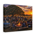 A square canvas wall art print showing a rustic outdoor campsite at sunset, with people gathered around a fire pit under a large tree, parked vintage trucks, and a warm orange sky. The canvas is photographed at an angle against a plain white background.