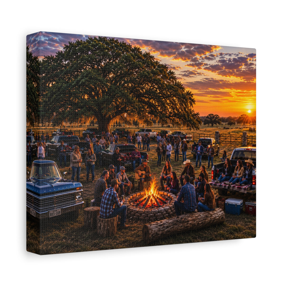 A square canvas wall art print showing a rustic outdoor campsite at sunset, with people gathered around a fire pit under a large tree, parked vintage trucks, and a warm orange sky. The canvas is photographed at an angle against a plain white background.