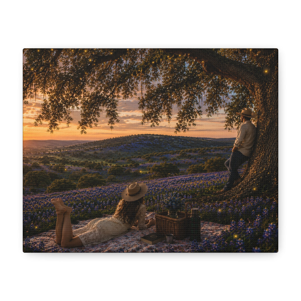 A rectangular wall art print or canvas showing a romantic outdoor picnic scene under a large tree at sunset, with rolling hills covered in blue flowers in the background. The artwork is centered on a plain white background.