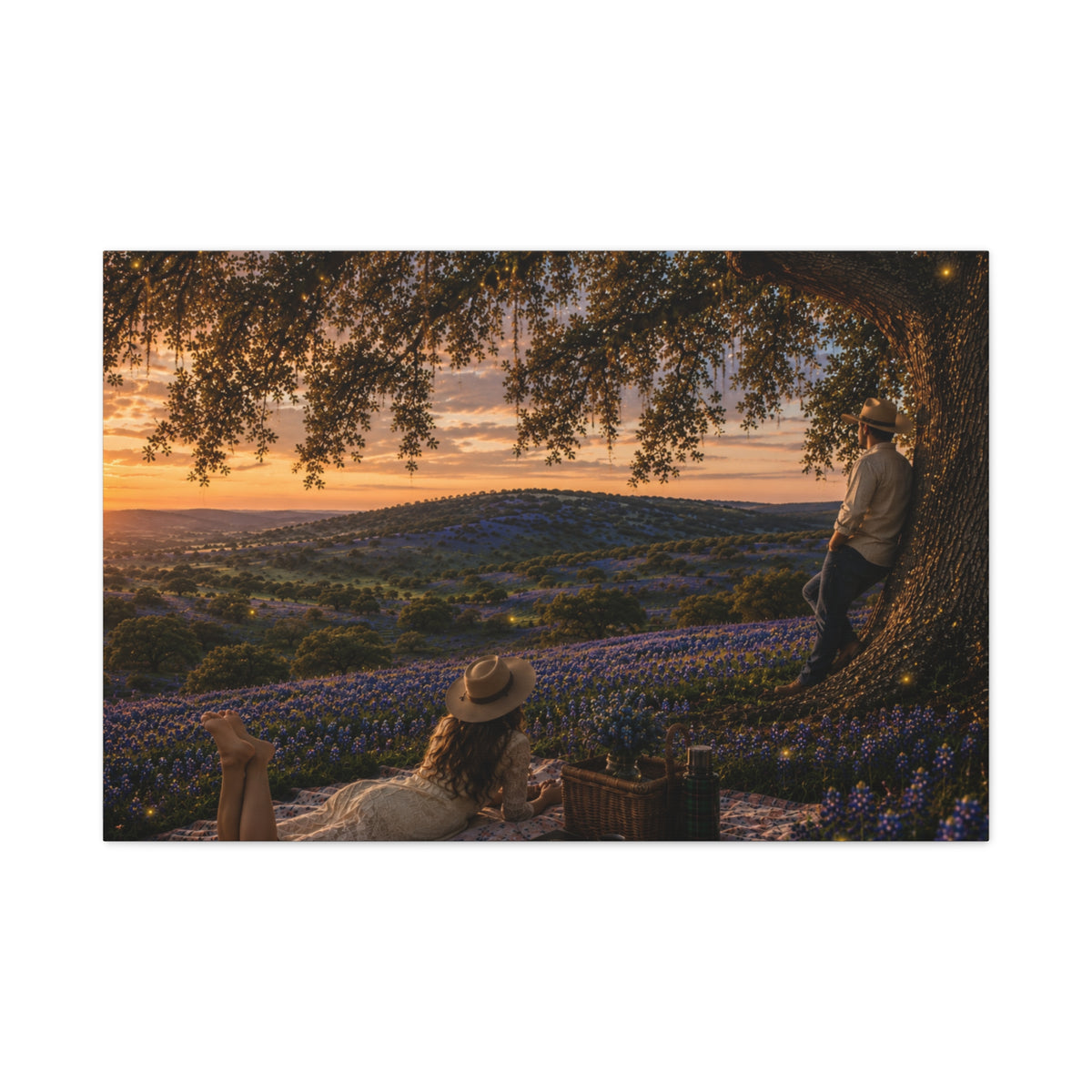 A rectangular wall art print or canvas showing a romantic outdoor picnic scene under a large tree at sunset, with rolling hills covered in blue flowers in the background. The artwork is centered on a plain white background.