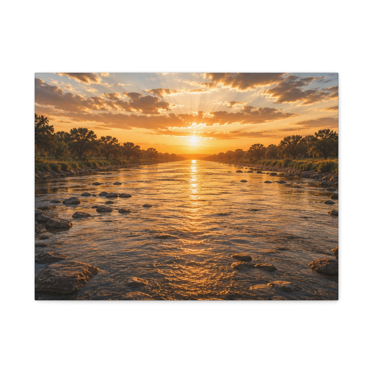 A rectangular The River canvas print showing a golden sunset over a shallow river, with rocks in the water, tree-lined banks, glowing reflections, and sunbeams breaking through the clouds, photographed on a white background.