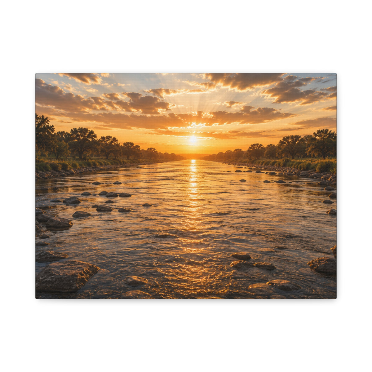 A rectangular The River canvas print showing a golden sunset over a shallow river, with rocks in the water, tree-lined banks, glowing reflections, and sunbeams breaking through the clouds, photographed on a white background.
