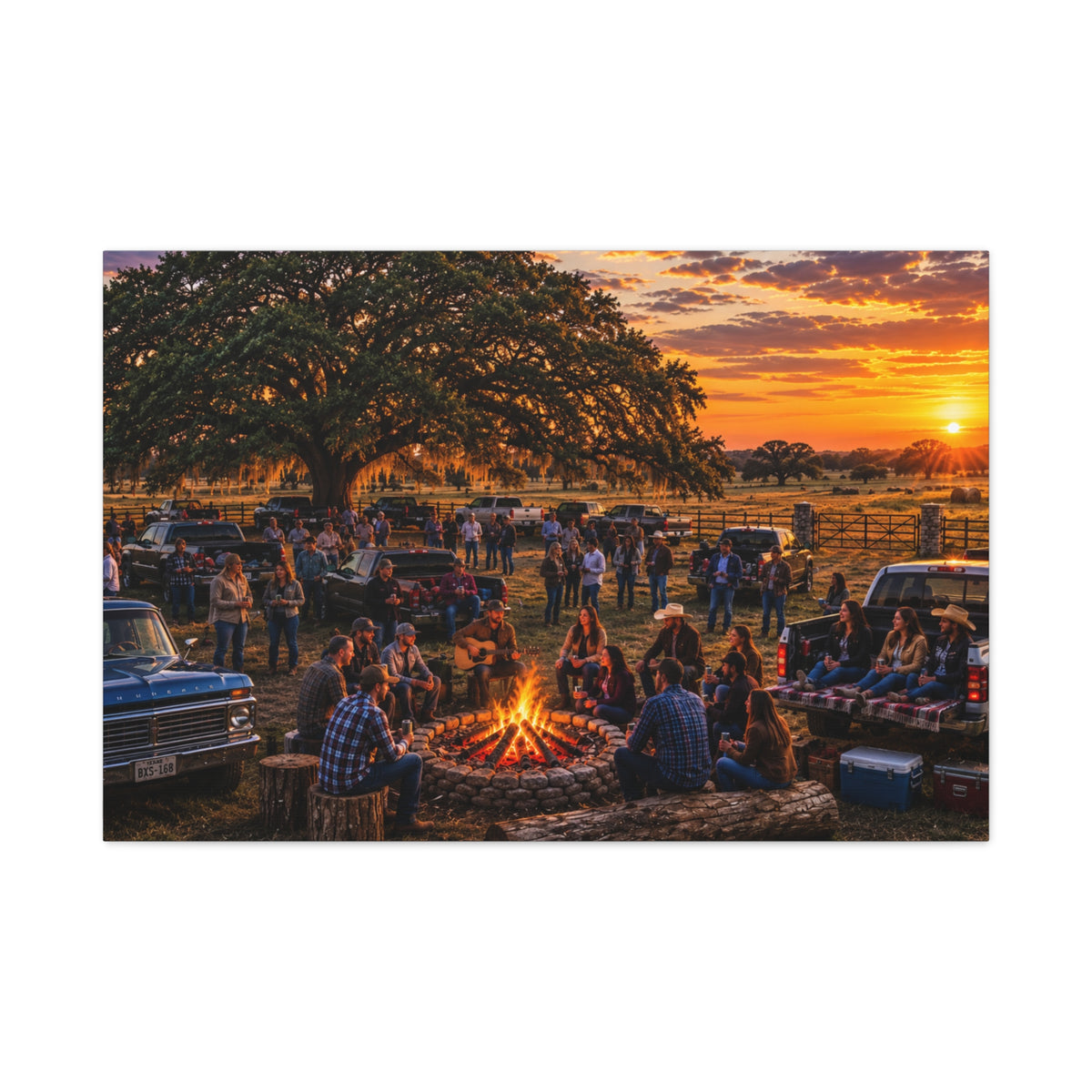 A rectangular wall art print showing a rustic outdoor campsite scene at sunset, with a large tree, people gathered around a fire pit, pickup trucks, and a warm orange sky. The print is centered on a light gray background.