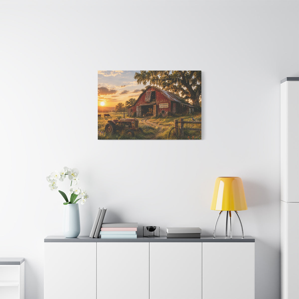 The Old Red Barn canvas print depicting a weathered red cattle barn beneath a moss-draped oak at sunset, with a vintage tractor, grazing cows, a wooden fence, and wildflowers in the foreground.