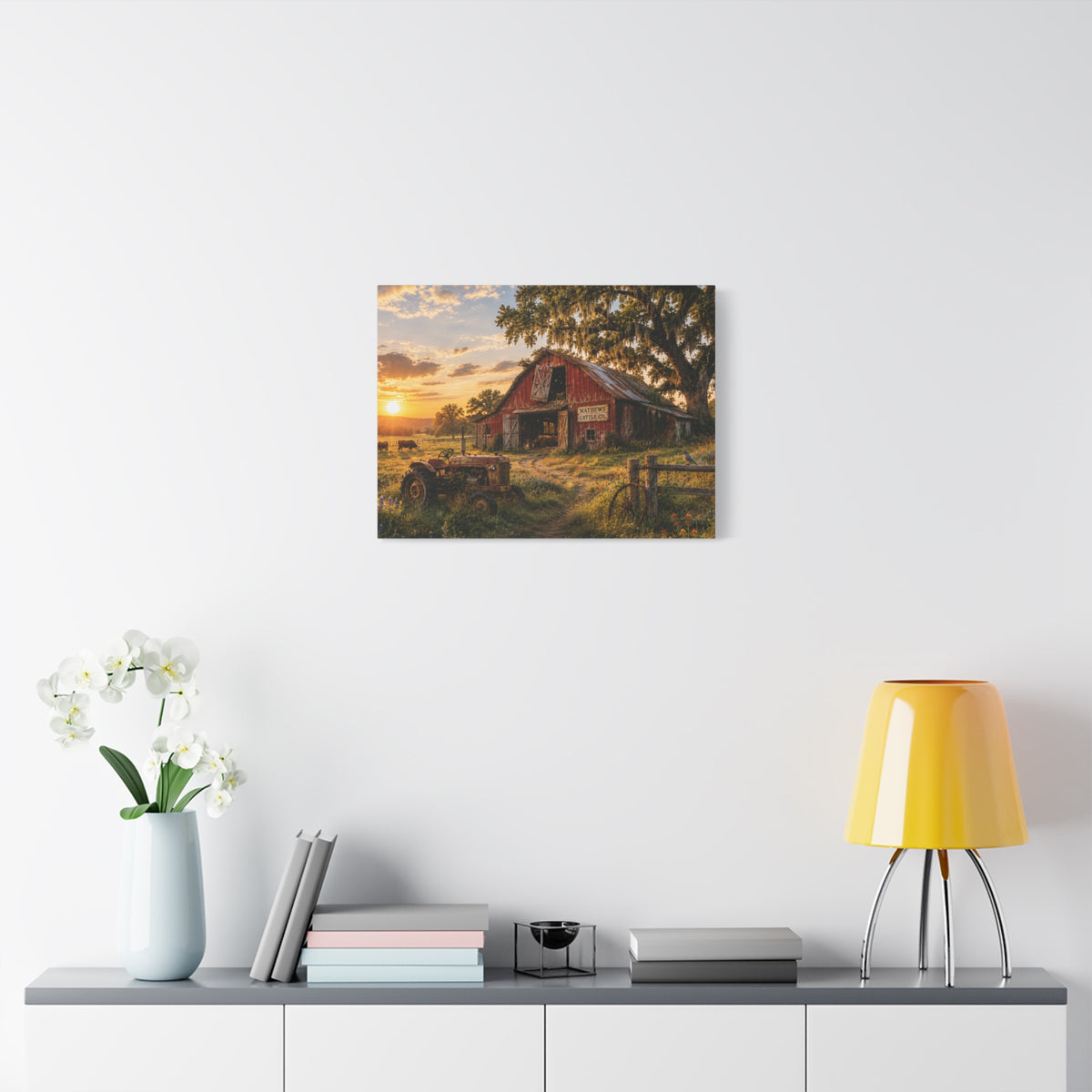 The Old Red Barn canvas print depicting a weathered red cattle barn beneath a moss-draped oak at sunset, with a vintage tractor, grazing cows, a wooden fence, and wildflowers in the foreground.