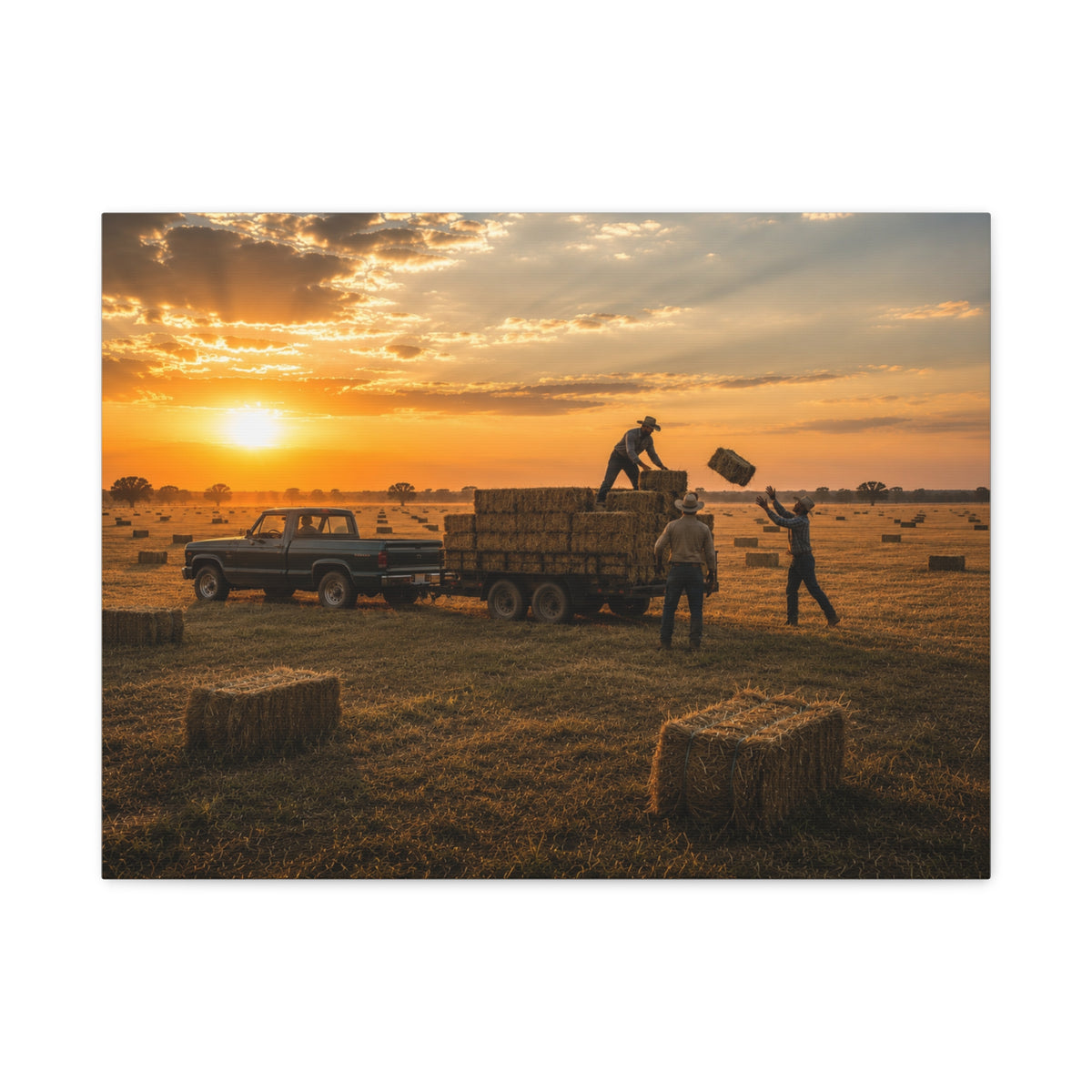 A rectangular Hay Season canvas print showing farmworkers loading rectangular hay bales onto a flatbed trailer beside a pickup truck in a golden field at sunset, photographed on a white background.