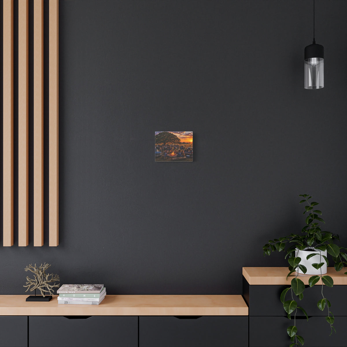 Decorative poster on a dark wall with a wooden shelf and plant in the foreground