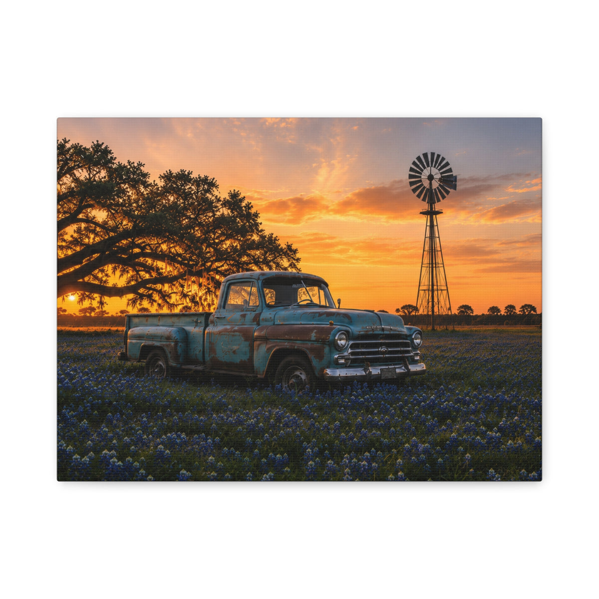 A rectangular The Windmill canvas print showing a weathered blue vintage pickup in a field of bluebonnets at sunset, with a windmill and large oak tree in the background, photographed on a white background.